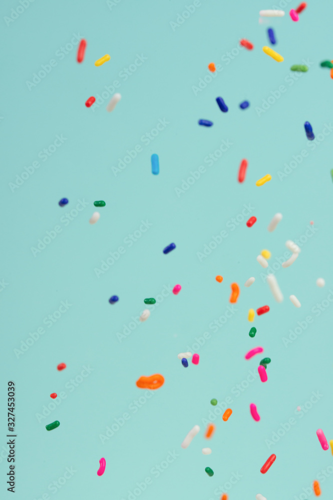 Falling pieces of colored caramel on a light background. Texture for design. Freezing in motion. Falling pieces of colored caramel on a light background. Texture for design. Freezing in motion.