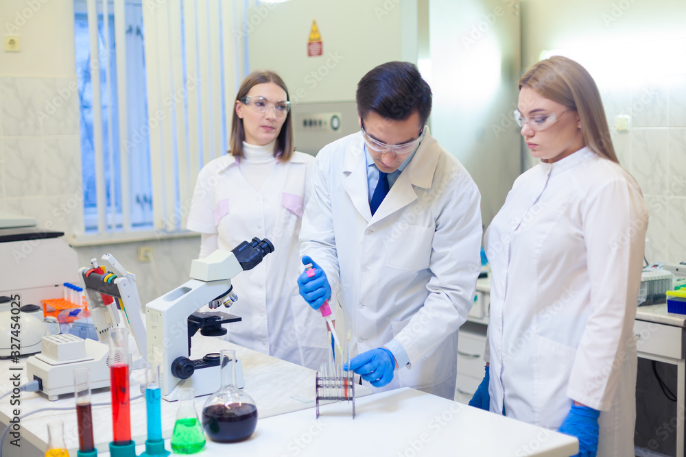 A group of scientists conducts research in a scientific laboratory using advanced technology A group of scientists conducts research in a scientific laboratory using advanced technology