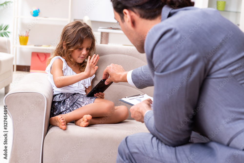 Child psychologist attending small girl Child psychologist attending small girl