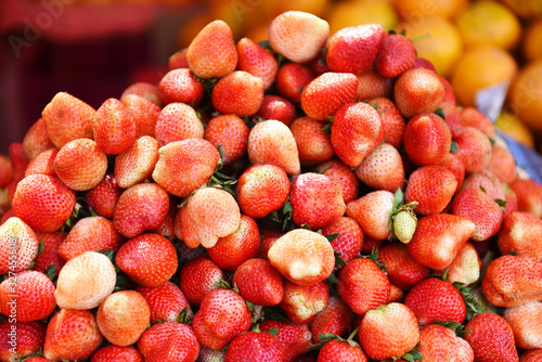 Harvested fresh strawberries background - Pile of ripe strawberry for sale in the market fruit