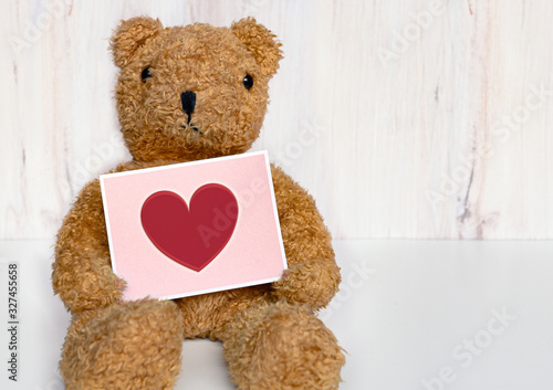 Bild auf Leinwand Teddy bear holding card with a heart on it, for get well, I love you, happy moth