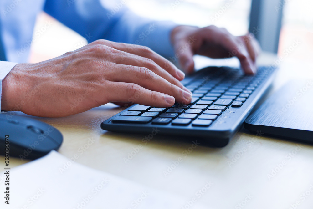 Close up of typing male hand on keyboard concept - Businessman working on keyboard and mouse computer man sitting on the table and using internet technology at workplace in office Close up of typing male hand on keyboard concept - Businessman working on keyboard and mouse computer man sitting on the table and using internet technology at workplace in office