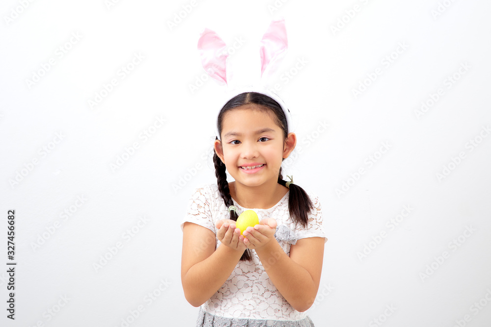 little child girl with easter bunny ears holding egg little child girl with easter bunny ears holding egg