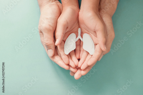 Adult and child hands holding lung, world tuberculosis TB day, lung cancer, copd, respiratory diseases concept