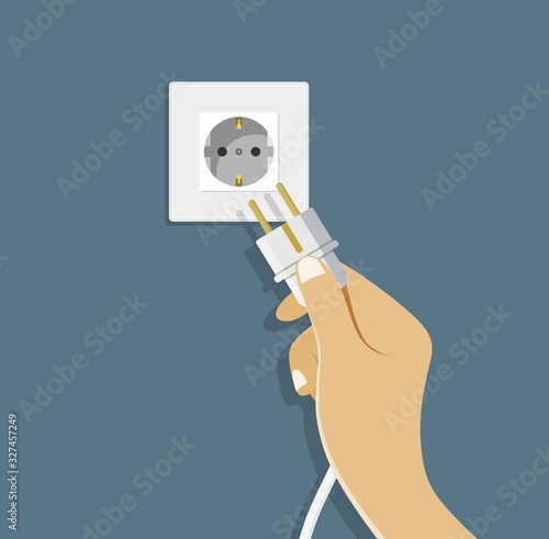Electrical outlet and hand with plug.