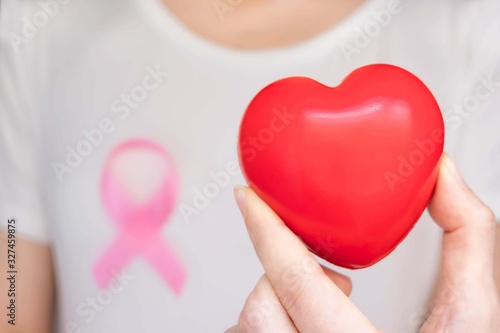 World Breast Cancer Day Concept,health care - woman wore white t-shirt,Pink ribbon for breast cancer awareness, symbolic bow color raising awareness on people living with women's breast tumor illness