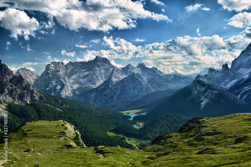 Incredible panorama of a mountain chain and a lake in a valley on a cloudy day in South Tyrol