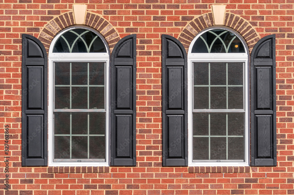 Large double pane hung arched sash windows with white frame, muntins