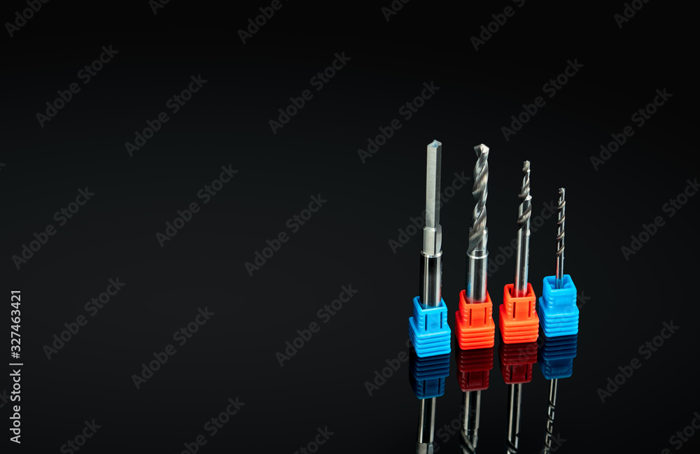 Special tools isolated on black background. Made to order special tools. Coated step drill detail. HSS cemented carbide. Carbide drilling tool for industrial applications. Engineering tools. Drilling. Special tools isolated on black background. Made to order special tools. Coated step drill detail. HSS cemented carbide. Carbide drilling tool for industrial applications. Engineering tools. Drilling.