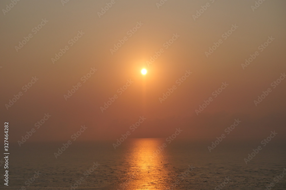 Aerial view of the sea at sunrise , The sun reflected on the water surface, Horizon began to turn orange with gold color in tropical areas, Thailand Aerial view of the sea at sunrise , The sun reflected on the water surface, Horizon began to turn orange with gold color in tropical areas, Thailand