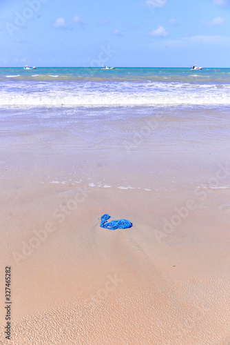 blue trash bag thrown on the beach, plastic bag thrown into the sea, World environment day