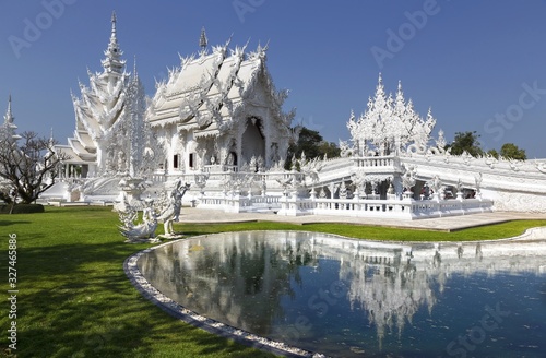 White Temple Exterior and Natural Park in Famous Wat Rong Khun Buddhist Complex, Chiang Rai Province, Thailand © Autumn Sky