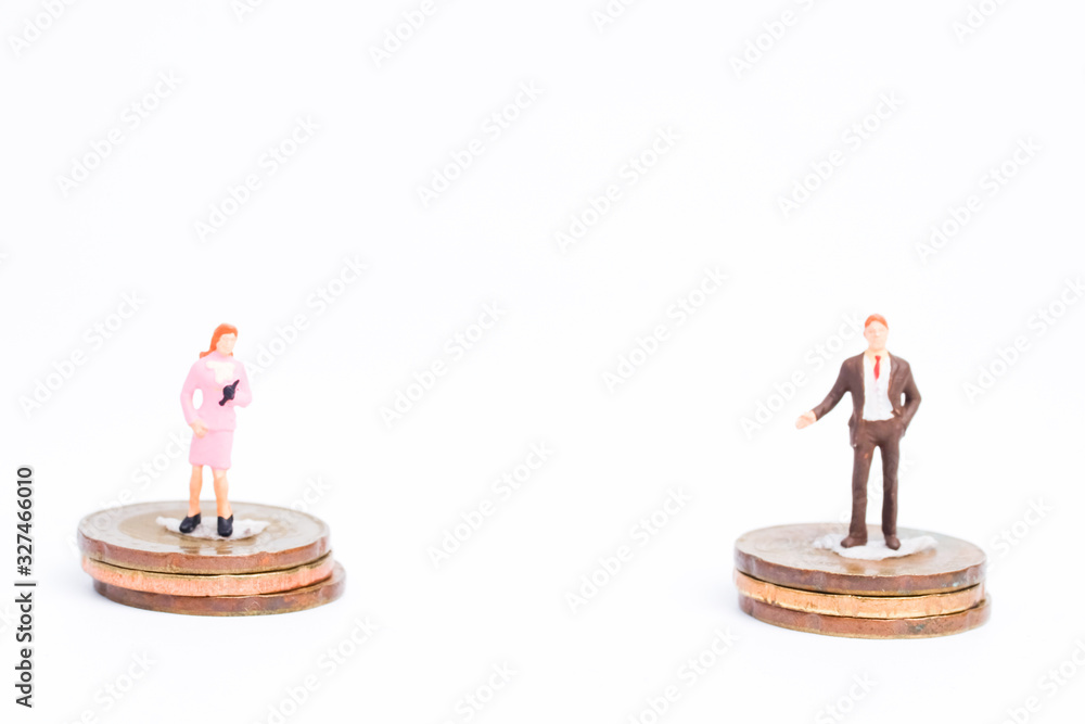 Fototapeta Gender equality in working environment and avoid sexism concept with miniature and coins insight.