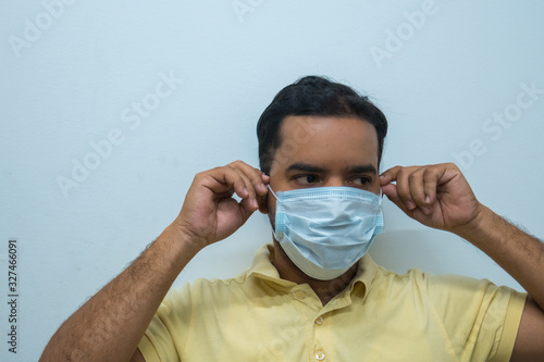 Man putting a mask on his face. Concept virus