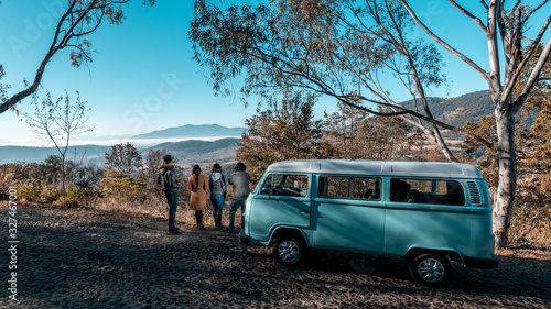 Tourists visiting a viewpoint and watching the landscape of the town of Amealco, Queretaro, Mexico, in the morning while the combi is parked where they travel