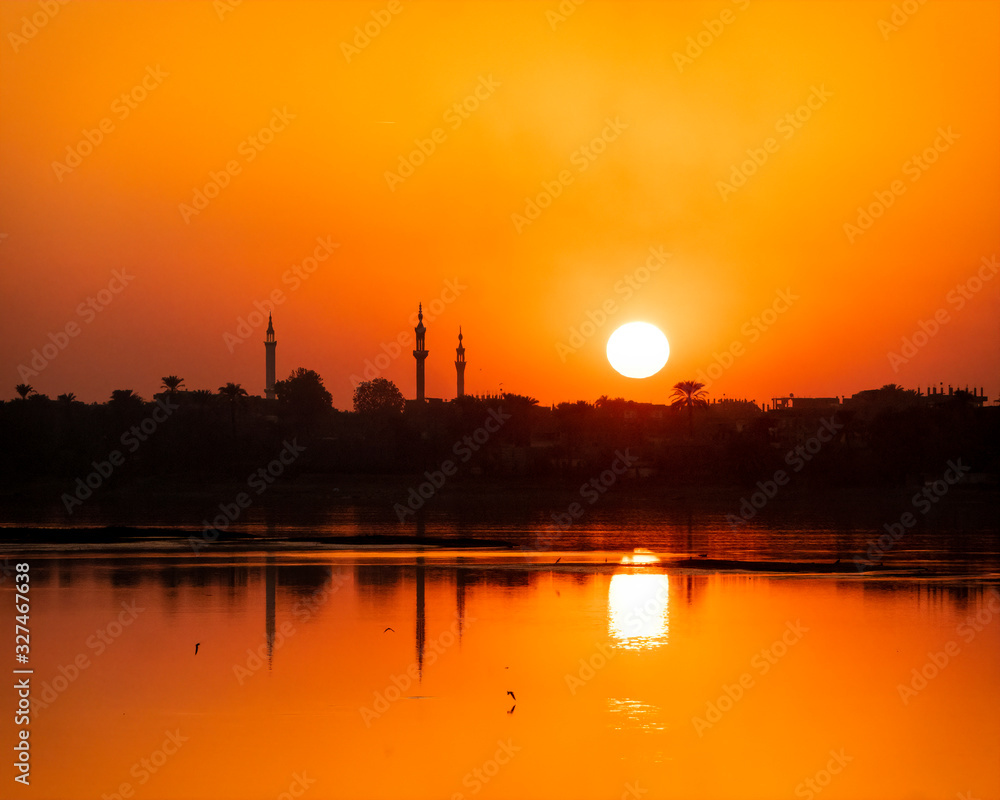Fototapeta premium Nile sunset at Karnak with minaret silhouettes