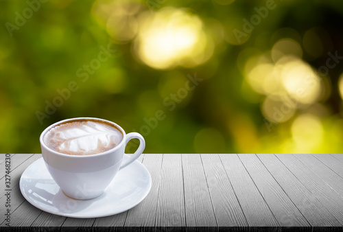 latte coffee cup background producton on the abstract green leaf background bokeh light photo