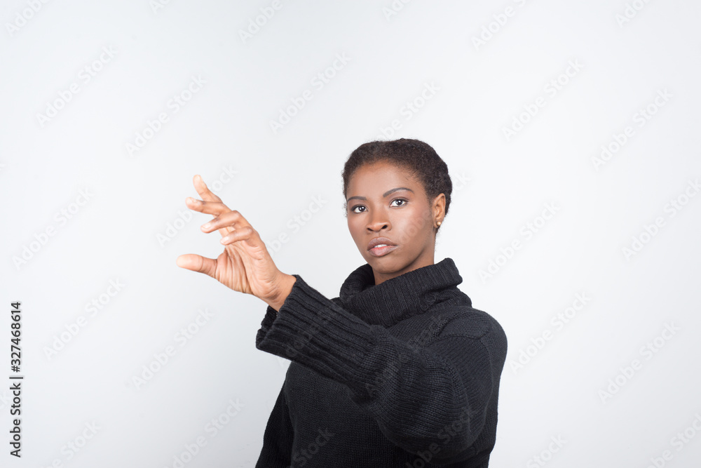 Beautiful serious woman touching virtual screen. Attractive young lady pressing on imaginary screen. Virtual screen concept Beautiful serious woman touching virtual screen. Attractive young lady pressing on imaginary screen. Virtual screen concept