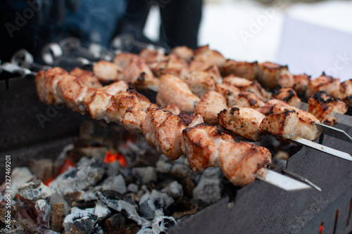 Roasted meat cooked at barbecue. Grilled kebab cooking on metal skewer. BBQ fresh beef meat chop slices. Traditional eastern dish, shish kebab.