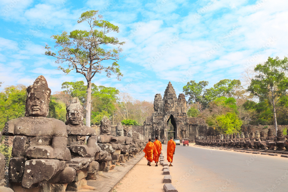 Fototapeta premium Three buddhist monks in Prasat Bayon Temple, Angkor, Siem Reap, Cambodia