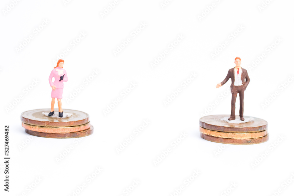Fototapeta Lady and men miniature on stack coin for income equality concept.