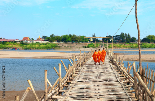 Photos Three buddhist monks on bamboo bridge across Mekong, Kampong Cham, Cambodia