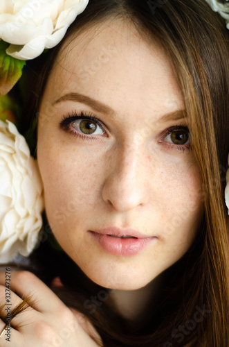 Closeup portrait of a young girl with flowers