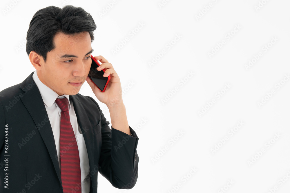 Young asian male is talking on the phone with business partner. Business concept Young asian male is talking on the phone with business partner. Business concept