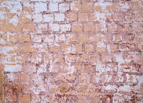 Background. An old red brick wall with peeled white paint and peeled plaster. © Александр Овсянников