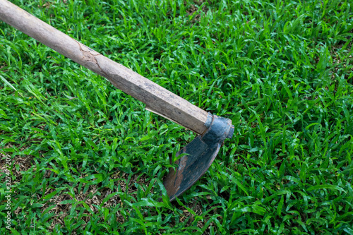 shovel for digging the soil, laying on the green grass.