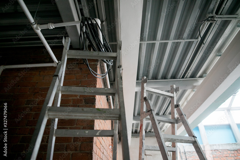 Obraz premium repair in the apartment, a staircase with a building tool