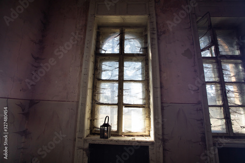 Spooky window with lantern and spider web.