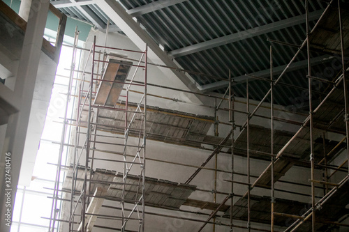 Scaffolding and wall plastering in buildings are under construction