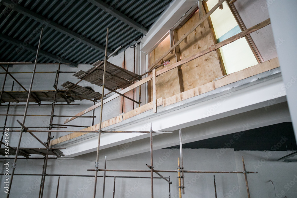 Scaffolding and wall plastering in buildings are under construction Scaffolding and wall plastering in buildings are under construction