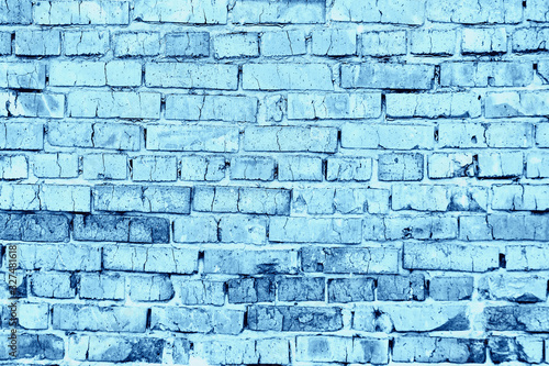 Background concept, old brick wall tinted in blue color.