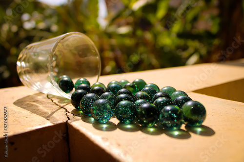  1. Single glass green marble ball with a nice shadow and impressive light with blur background
