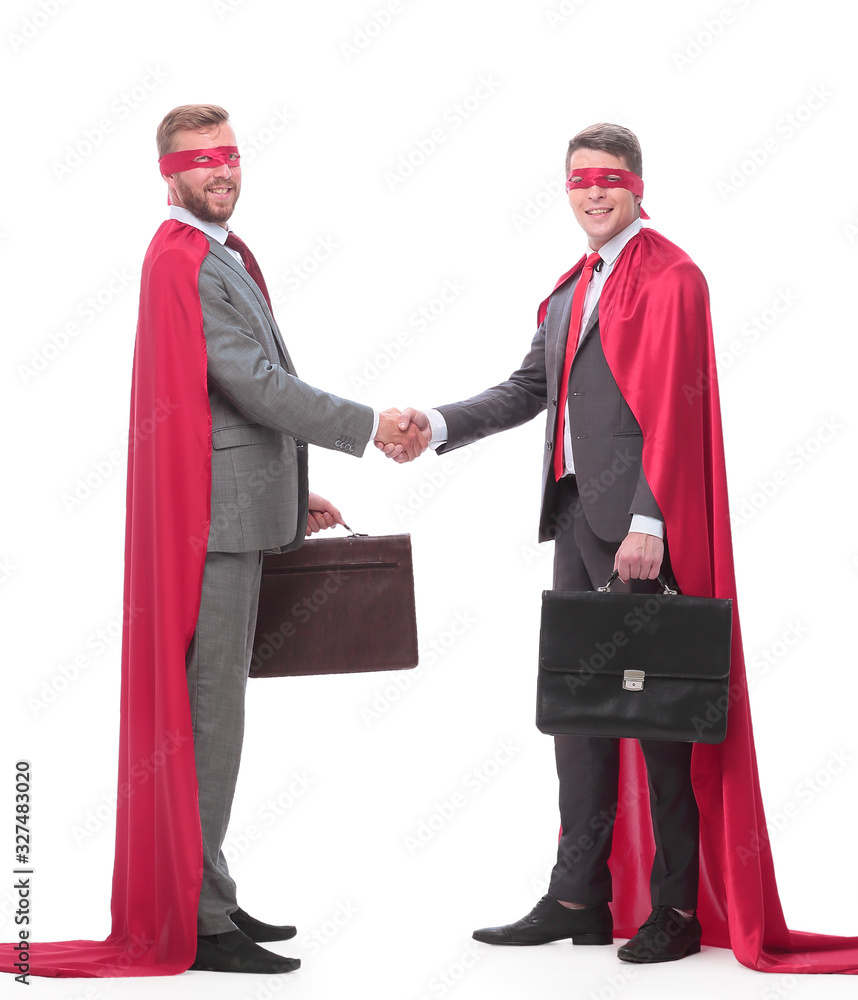 business partners in superhero capes shaking hands. isolated on white