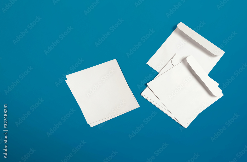 White envelope and post card on background. Top view blank envelope mockup and blank letterhead presentation template. Empty sheet for your design. White envelope and post card on background. Top view blank envelope mockup and blank letterhead presentation template. Empty sheet for your design.