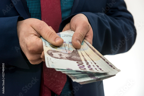 Wallpaper Mural businessman gives bribe or pay, in isolation. UAH. 1000 new banknote Ukrainian money Torontodigital.ca