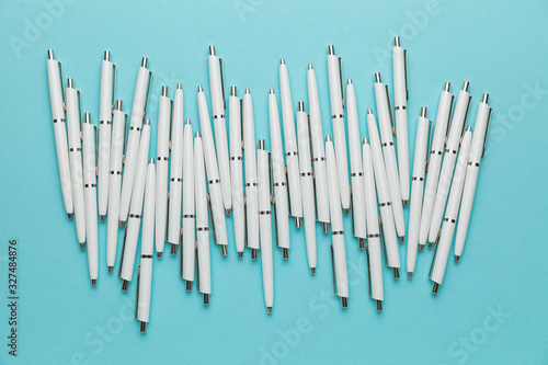 Many pens on a blue background as a symbol of a business meeting  corporate seminar or conference.