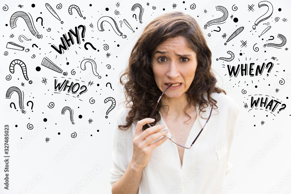 Alarming young woman biting eyeglasses. Worried female thinking something bad while posing in studio. Fear, stress concept Alarming young woman biting eyeglasses. Worried female thinking something bad while posing in studio. Fear, stress concept