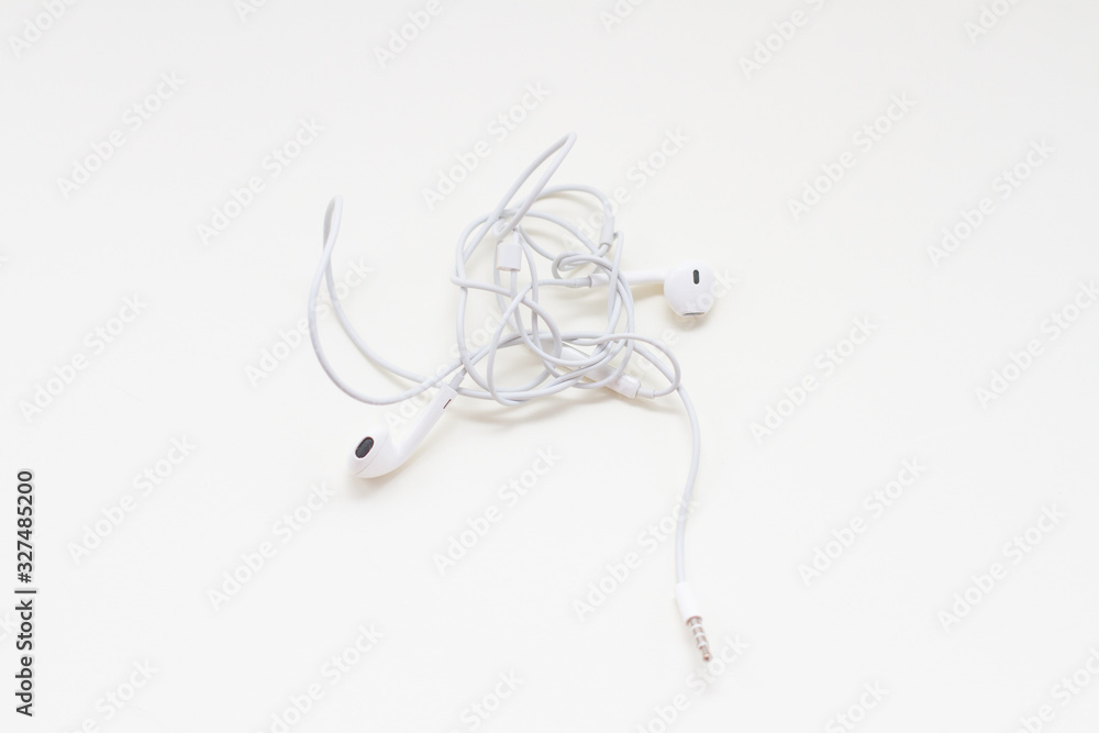 Fototapeta premium a white wired earbuds with tangled wires