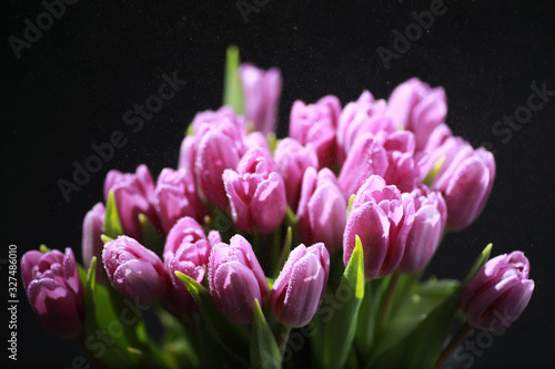 Fototapeta Naklejka Na Ścianę i Meble -  Bouquet of fresh flowers. Holiday gift to your loved one. Background St. Valentine's Day. Rose, tulip, iris flower arrangement.