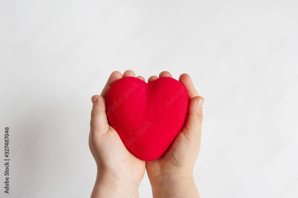 Child hands holding red heart, health care, donate and family insurance concept, world heart day, world health day, family love concept. Child hands holding red heart, health care, donate and family insurance concept, world heart day, world health day, family love concept.