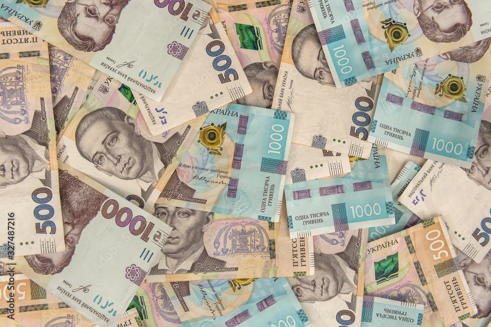 Background of new 1000 500 200 UAH banknotes on desk. money and save concept. Financial background Background of new 1000 500 200 UAH banknotes on desk. money and save concept. Financial background