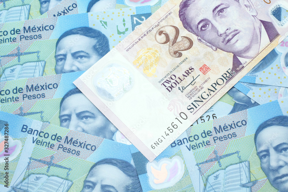 A close up image of a two dollar bill from Singapore close up in macro with Mexican twenty peso bank notes A close up image of a two dollar bill from Singapore close up in macro with Mexican twenty peso bank notes