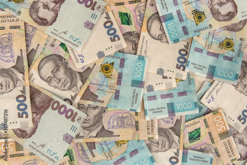 Wallpaper Mural Background of new 1000 500 200 UAH  banknotes on desk. money and save concept. Financial background Torontodigital.ca