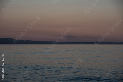 Landscape with the sea and trees in the evening haze © savelov