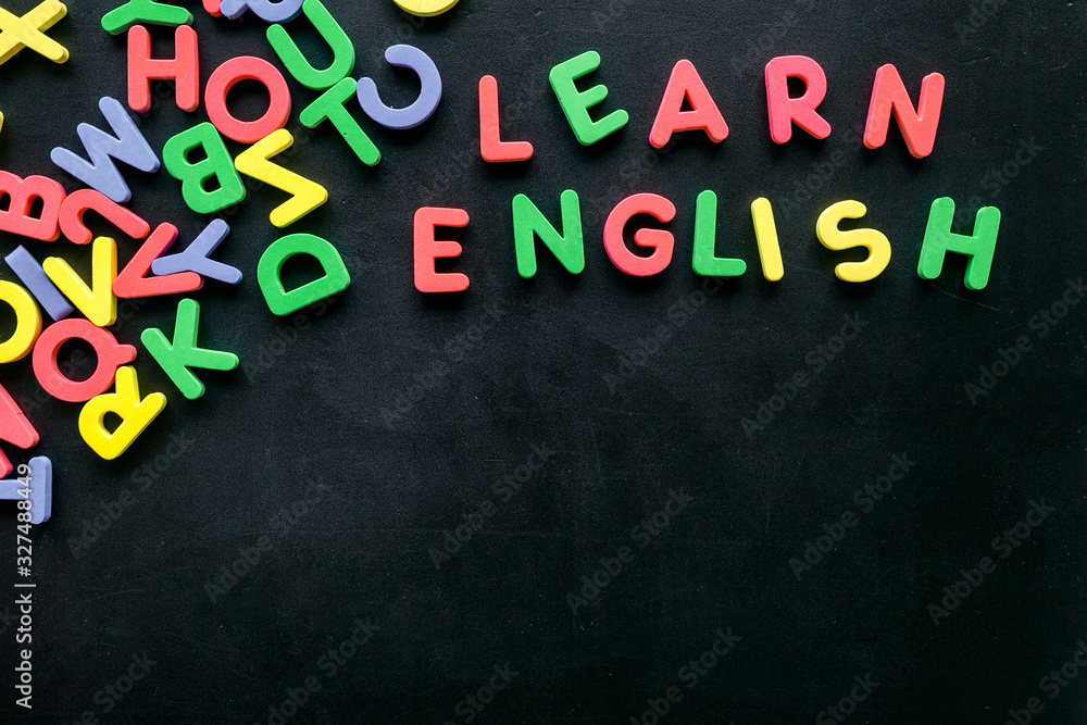 Learn English text near letters on black background top-down copy space Learn English text near letters on black background top-down copy space