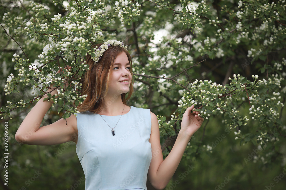Girl in blue dress in green park